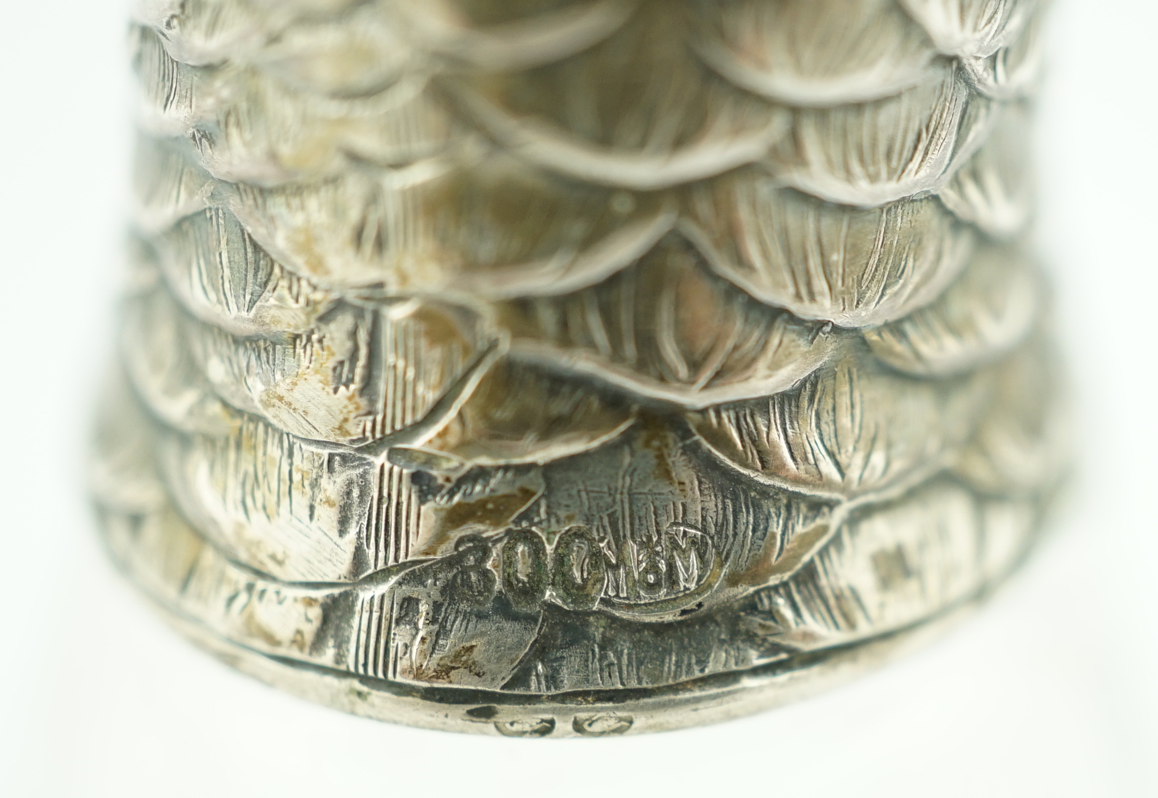 An early 20th century German 800 standard silver mounted glass pepperette, the cover modelled as the head of a parrot